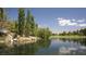 Scenic pond view with lush greenery and mature trees. Serene location for residents at 4410 E Brusca Way, Pahrump, NV 89061