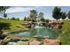 Picturesque waterfall cascading into a pond surrounded by lush landscaping at 4410 E Brusca Way, Pahrump, NV 89061