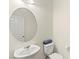 Bathroom featuring a pedestal sink, oval mirror, and toilet at 4533 Lime Straight Dr, Las Vegas, NV 89115