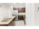 Well-lit kitchen featuring stainless steel appliances, granite countertops and dark wood cabinetry at 4533 Lime Straight Dr, Las Vegas, NV 89115