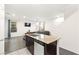 Kitchen island with stainless steel dishwasher and adjacent living room at 4533 Lime Straight Dr, Las Vegas, NV 89115