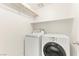 Neat laundry room with washer, dryer and upper shelving for storage at 4533 Lime Straight Dr, Las Vegas, NV 89115