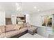 Bright living room features neutral colors, modern lighting, tile flooring, and direct access to the outdoor living space at 4533 Lime Straight Dr, Las Vegas, NV 89115