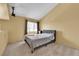 A bedroom with carpeted floors, large window and mounted tv bracket at 4770 Topaz St # 108, Las Vegas, NV 89121