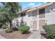 Charming townhouse featuring a well-kept front yard with mature trees and landscaping at 4770 Topaz St # 108, Las Vegas, NV 89121