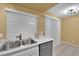 Bright kitchen featuring modern appliances and a double sink near large windows at 4770 Topaz St # 108, Las Vegas, NV 89121