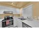 Updated kitchen with white cabinetry, modern appliances, and convenient sink placement at 4770 Topaz St # 108, Las Vegas, NV 89121