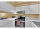 Efficient kitchen with white cabinetry, modern appliances, and ample counter space at 4770 Topaz St # 108, Las Vegas, NV 89121