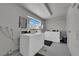 Well-lit laundry room with white washer and dryer units and exterior window at 4770 Topaz St # 108, Las Vegas, NV 89121
