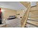 Bright living room with tile flooring and staircase leading to a second level at 4770 Topaz St # 108, Las Vegas, NV 89121