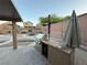 Outdoor kitchen with grill in backyard with desert landscaping and gravel paths at 5019 Quiet Falls Ct, Las Vegas, NV 89141