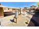 Beautiful backyard featuring a built-in grill, covered patio, and landscaping at 5019 Quiet Falls Ct, Las Vegas, NV 89141