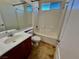Bathroom features a vanity, toilet, and shower-tub combo with tile surround at 5019 Quiet Falls Ct, Las Vegas, NV 89141