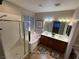 A luxurious bathroom featuring a walk-in shower, soaking tub, and double vanity sinks at 5019 Quiet Falls Ct, Las Vegas, NV 89141