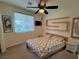 Cozy bedroom features a ceiling fan, window with blinds, and stylish furnishings at 5019 Quiet Falls Ct, Las Vegas, NV 89141