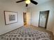 A well-lit bedroom features a ceiling fan, closet, and minimalist decor at 5019 Quiet Falls Ct, Las Vegas, NV 89141