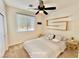 Bedroom features a ceiling fan, window, neutral walls, and simple decor at 5019 Quiet Falls Ct, Las Vegas, NV 89141