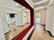 Entryway with tiled floors, red accent wall, and view into study and front door at 5019 Quiet Falls Ct, Las Vegas, NV 89141