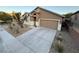 Home with concrete driveway and desert landscaping at 5019 Quiet Falls Ct, Las Vegas, NV 89141