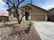 Inviting single-story home with a two-car garage and desert landscaping at 5019 Quiet Falls Ct, Las Vegas, NV 89141