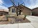 Inviting single-story home with a two-car garage and desert landscaping at 5019 Quiet Falls Ct, Las Vegas, NV 89141