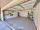 Spacious two-car garage boasts ample shelving for storage, keeping your space organized at 5019 Quiet Falls Ct, Las Vegas, NV 89141