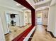 Hallway with open view into office and front door with neutral walls and unique flooring at 5019 Quiet Falls Ct, Las Vegas, NV 89141