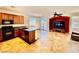 Open kitchen and living area with island, wood cabinets, and access to the backyard at 5019 Quiet Falls Ct, Las Vegas, NV 89141