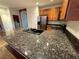 Kitchen featuring granite countertops, dark appliances and wood cabinets at 5019 Quiet Falls Ct, Las Vegas, NV 89141