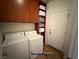 A well-organized laundry room features a washer, dryer, built-in storage, and a convenient folding area at 5019 Quiet Falls Ct, Las Vegas, NV 89141