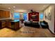 Open-concept living space with a granite kitchen island and designated living room at 5019 Quiet Falls Ct, Las Vegas, NV 89141
