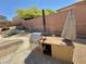 Backyard features an outdoor kitchen with stainless steel grill and spacious counter at 5019 Quiet Falls Ct, Las Vegas, NV 89141