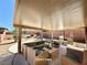 This covered patio includes an outdoor seating area and built in barbeque for enjoying the backyard at 5019 Quiet Falls Ct, Las Vegas, NV 89141