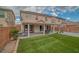 The home features a pristine backyard with artificial turf, a covered patio, and a brick perimeter at 5021 Apache Valley Ave, Las Vegas, NV 89131