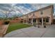 This large backyard offers artificial turf, mature landscaping, a covered patio, and block wall fencing at 5021 Apache Valley Ave, Las Vegas, NV 89131