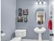 Stylish half-bathroom featuring blue walls, a pedestal sink, and modern decor at 5021 Apache Valley Ave, Las Vegas, NV 89131