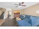 Comfortable living room featuring dark wood floors and a plush blue sectional at 5021 Apache Valley Ave, Las Vegas, NV 89131