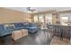 Open-concept living area featuring dark wood floors, a large sectional, and bar seating at 5021 Apache Valley Ave, Las Vegas, NV 89131