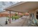 Covered patio boasts ample space for dining and lounging with a green lawn just steps away at 5021 Apache Valley Ave, Las Vegas, NV 89131