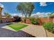 Lush backyard with a putting green, brick patio, and vibrant landscaping at 5448 Tulip Hill Ave, Las Vegas, NV 89141