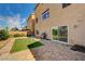 A well-kept backyard offers a putting green, brick patio and seamless access to indoor living through a sliding glass door at 5448 Tulip Hill Ave, Las Vegas, NV 89141