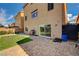 A backyard view shows a putting green, BBQ, and brick patio with a sliding glass door to the home at 5448 Tulip Hill Ave, Las Vegas, NV 89141