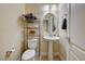 Cozy half bathroom with a pedestal sink and decorative shelving at 5448 Tulip Hill Ave, Las Vegas, NV 89141