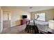 Bedroom with a bed, dresser with a TV, and exercise equipment at 5448 Tulip Hill Ave, Las Vegas, NV 89141