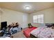 Bedroom with a cluttered desk area, natural light, and a cozy space for rest and study at 5448 Tulip Hill Ave, Las Vegas, NV 89141