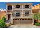 Two-story home featuring a spacious two car garage and a small balcony at 5448 Tulip Hill Ave, Las Vegas, NV 89141