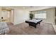 Open floor plan shows game room complete with a pool table, carpeted floors and neutral colored walls at 5448 Tulip Hill Ave, Las Vegas, NV 89141
