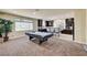 Open floor plan featuring a game room and partial view of the adjacent kitchen at 5448 Tulip Hill Ave, Las Vegas, NV 89141