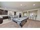 Open floor plan showcasing a game room with access to living and kitchen areas at 5448 Tulip Hill Ave, Las Vegas, NV 89141