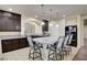 Kitchen featuring dark cabinets, granite countertops and a large center island at 5448 Tulip Hill Ave, Las Vegas, NV 89141